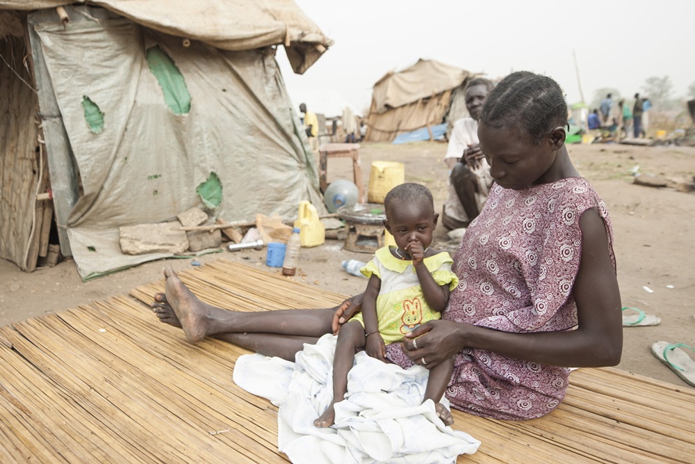 Woman sits with her daughter in displaced persons camp, Juba, South Sudan.